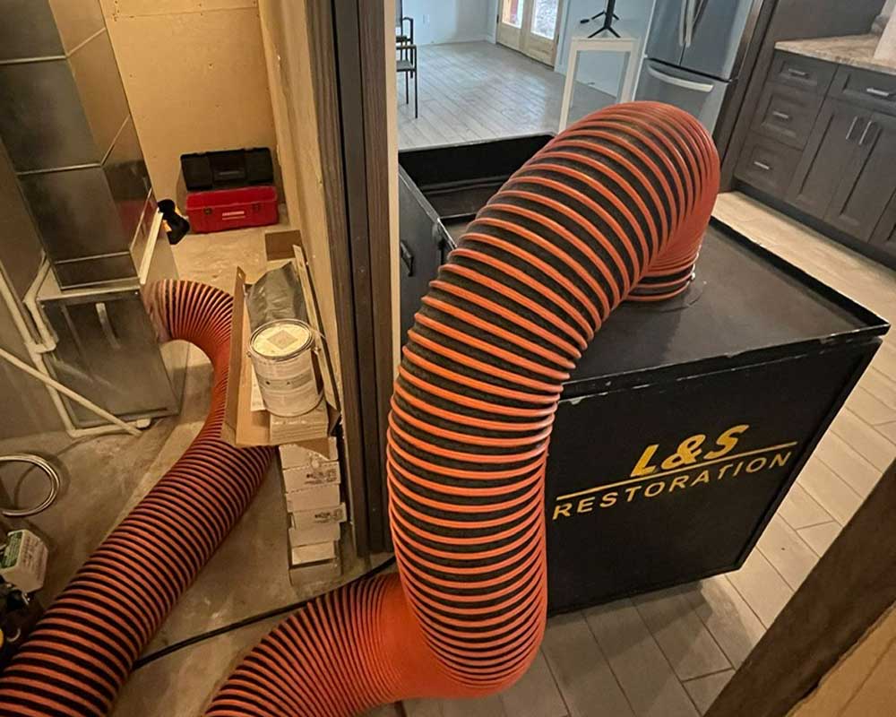 L&S Restoration duct cleaning machine connected to a home's furnace ductwork